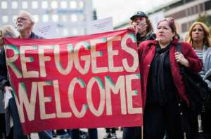 People hold a banner 'refugees welcome' as they take part in a demonstration in solidarity with refugees seeking asylum in Europe after fleeing their home countries in Stockholm, Sweden, on September 12, 2015. (Picture Via: MSN News.com)