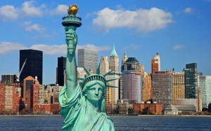 “Give me your tired, your poor, Your huddled masses yearning to breathe free, The wretched refuse of your teeming shore. Send these, the homeless, tempest-tossed, to me: I lift my lamp beside the golden door.” (Picture via New York City Wallpapers)